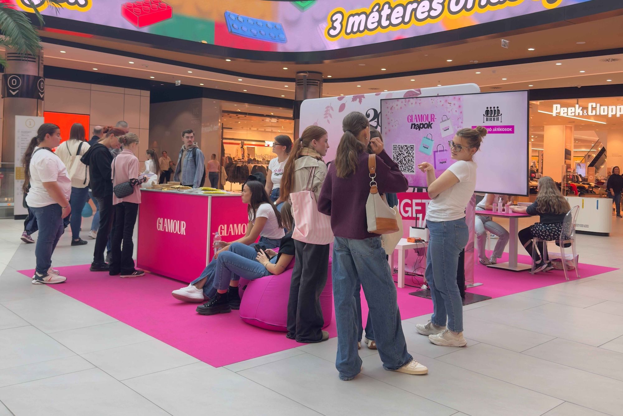 Visitors engaging with Glamour Coupon Days activation experience